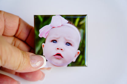 Hand holding 2x2 custom square photo magnet – size reference