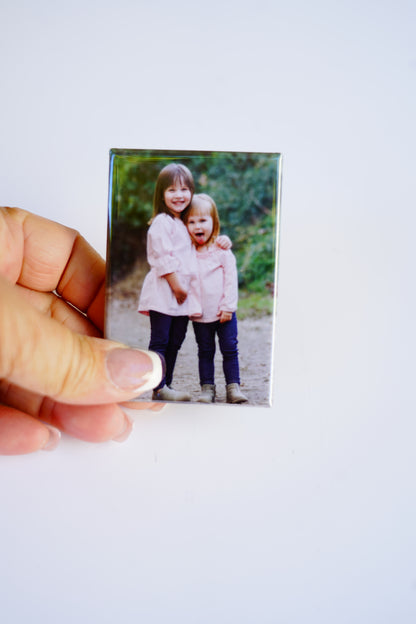 Hand holding custom 2×3 rectangle magnet – size reference