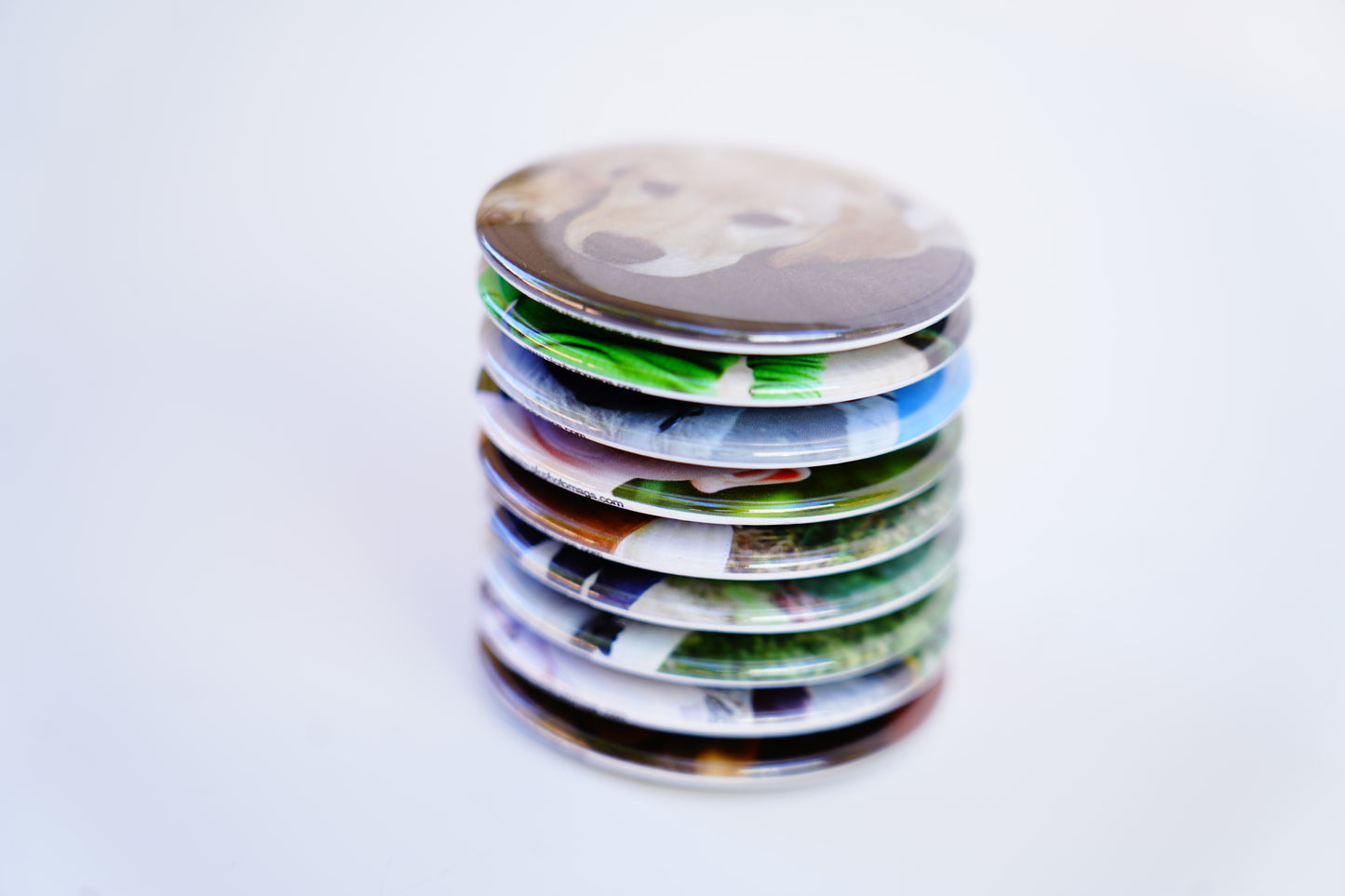 Stack of custom 2-inch circle photo magnets – premium printed finish