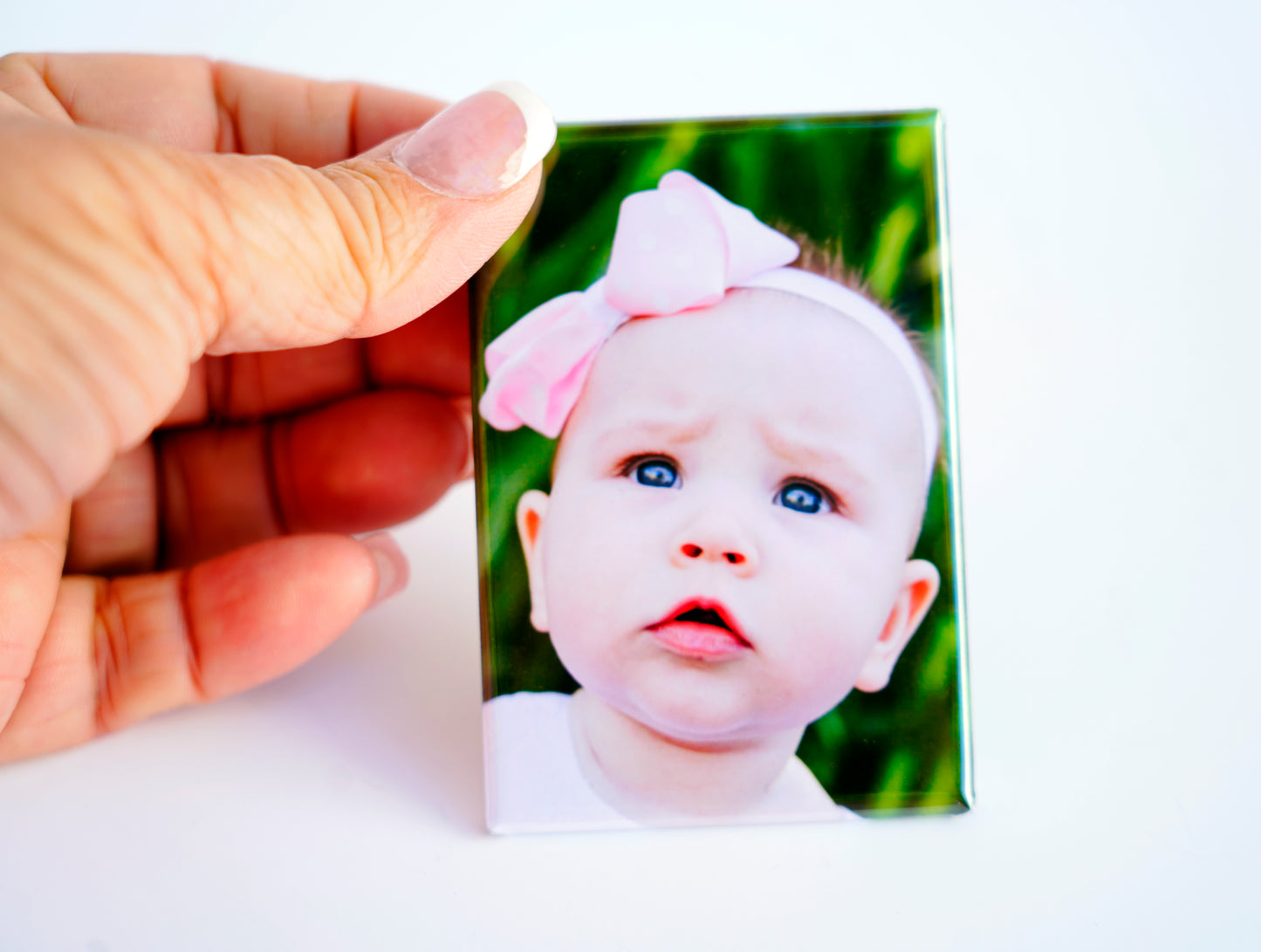 Hand holding custom 2×3 rectangle magnet – size reference