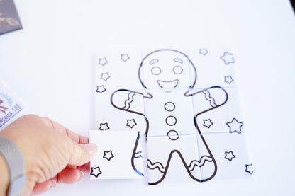 Hand placing puzzle piece – dry erase gingerbread magnet